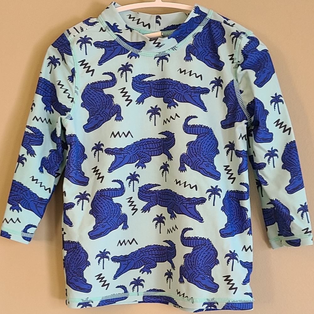 Blue rashguard swimsuit top with alligator print
